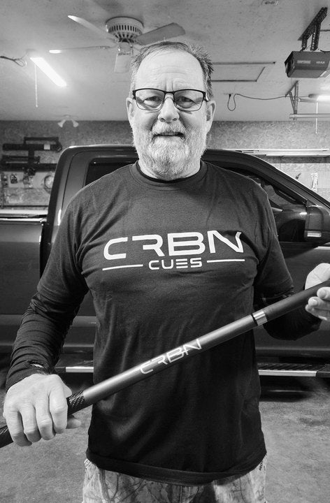 CRBN Cues customer in a CRBN Cues shirt holding his CRBN cue