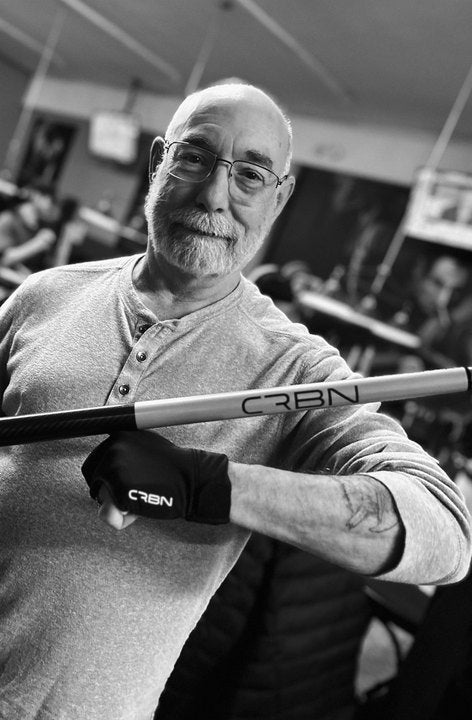 CRBN Cues customer in a pool hall holding his CRBN cue