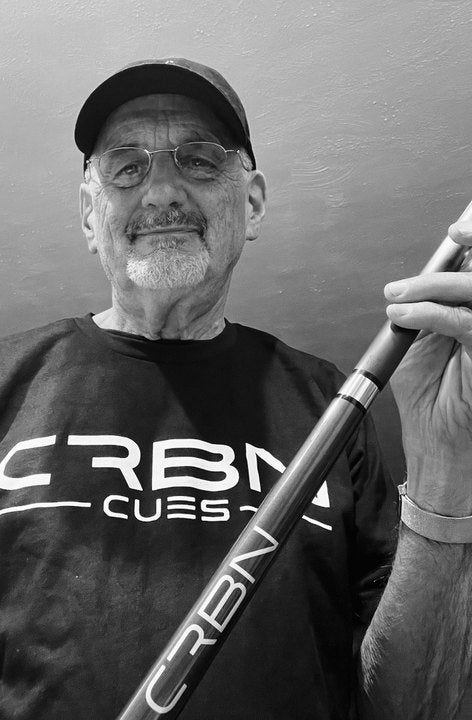 CRBN Cues customer in a cap and CRBN Cues shirt with his CRBN cue
