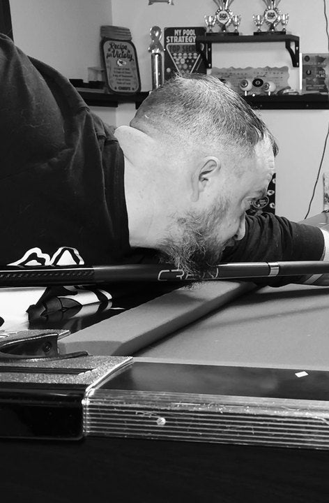 CRBN Cues customer down on a shot with his CRBN cue