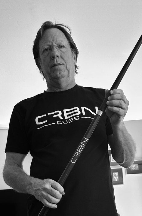 CRBN Cues customer in a CRBN Cues shirt holding his CRBN cue