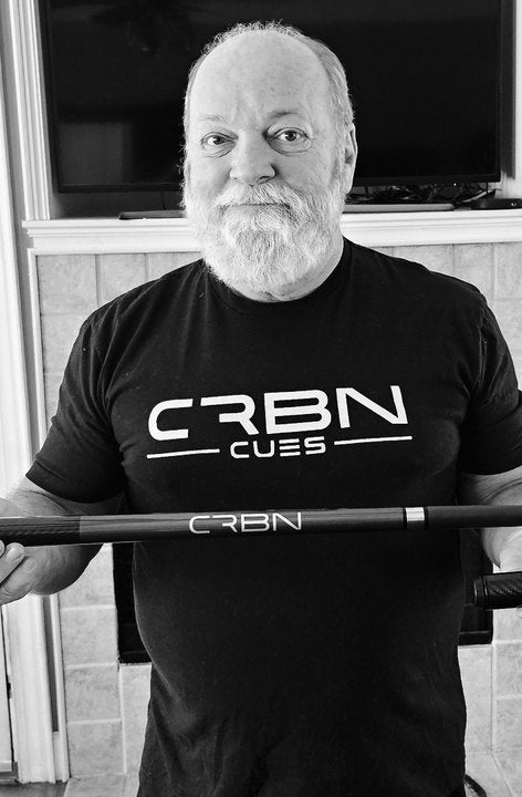 CRBN Cues customer in a CRBN Cues shirt holding his CRBN cue level