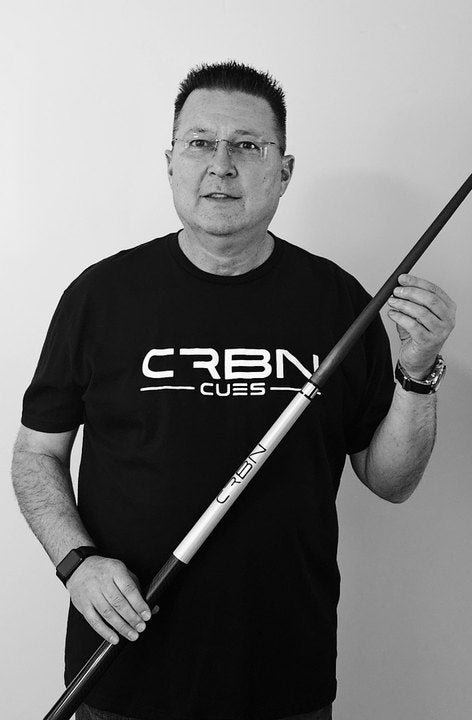 CRBN Cues customer in a CRBN Cues shirt standing with his CRBN cue