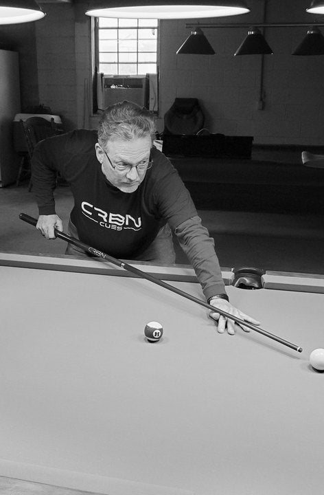 CRBN Cues customer down on a shot with his CRBN cue