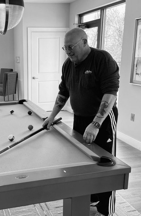 CRBN Cues customer shooting at his home table with a CRBN cue